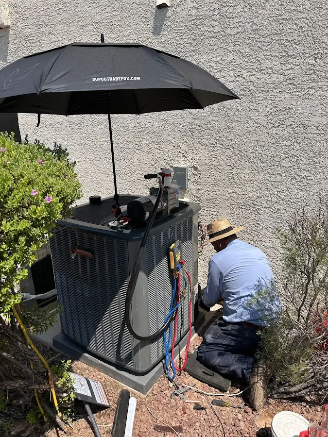 HVAC technician performing outdoor AC maintenance in Winter Garden