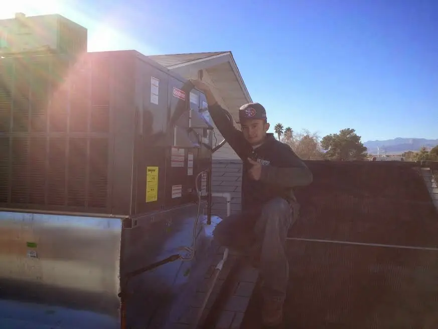 HVAC technician performing Heat Pump Repair on a rooftop unit in Winter Garden
